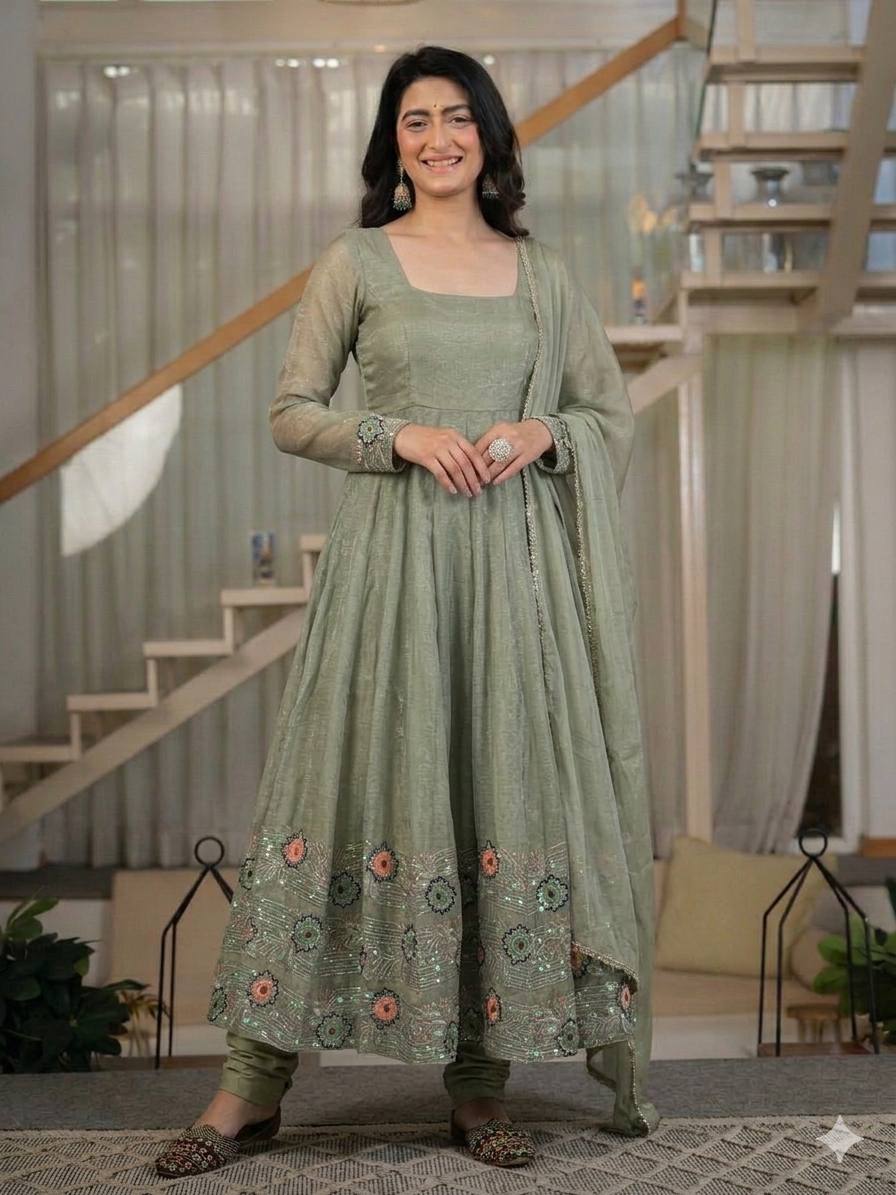 Ethereal Mehendi Green Flared Anarkali Suit Set Adorned with Luminous Sequined Floral Motifs, Embroidered Cuffs, and an Ornate Heritage Hem